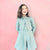 Girls Light Sage Colored Two Piece Trench Coat Styled Short Length Dress With Covered Belt Buckle For a Full Heritage Feel.